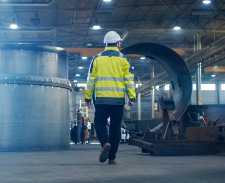 Industrial,Engineer,In,Hard,Hat,Wearing,Safety,Jacket,Walks,Through